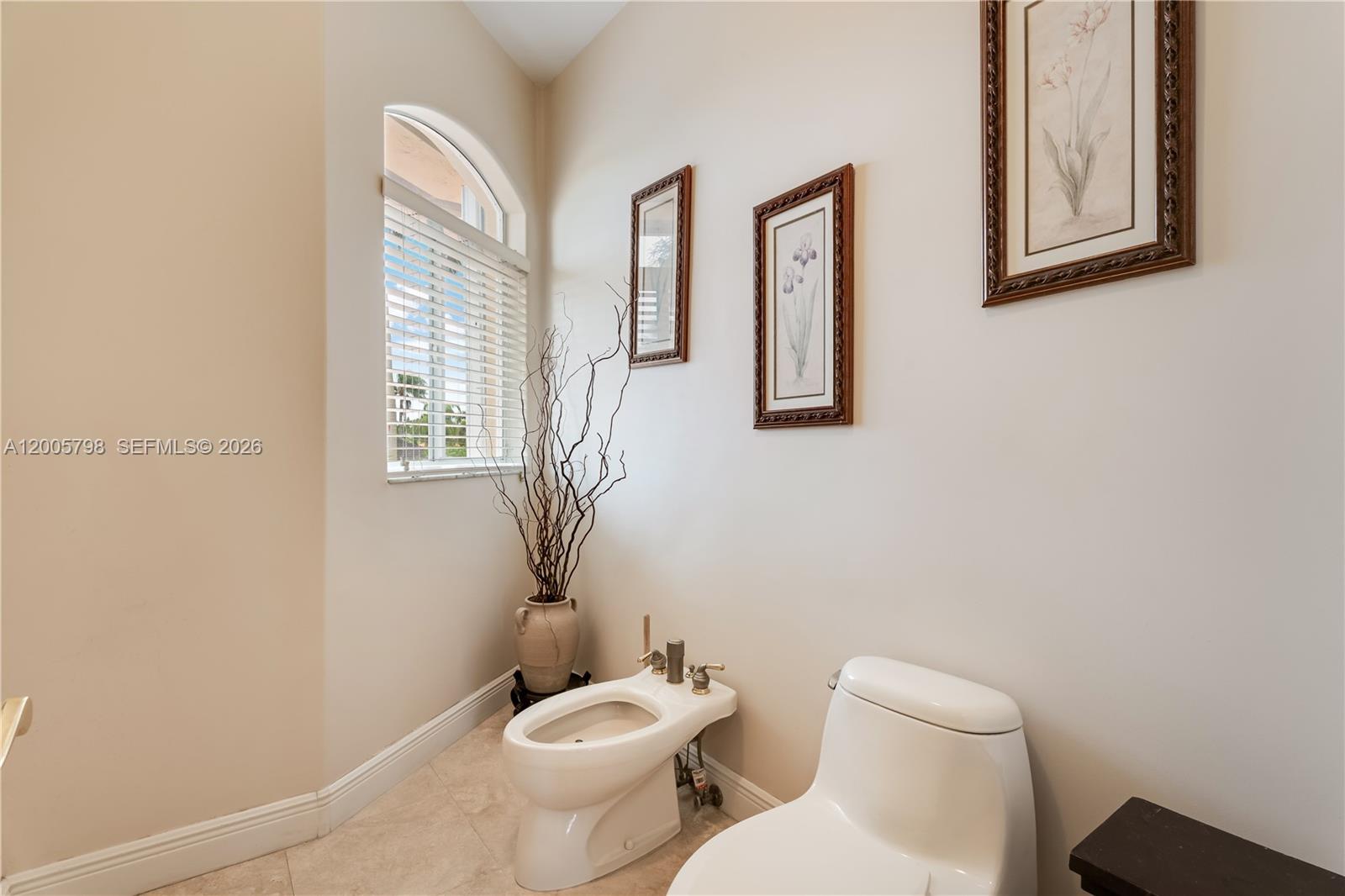 11071 Southwest 28th Street Miami, FL 33165 - Photo 39 of 78 a white toilet sitting next to a bathroom sink and tub