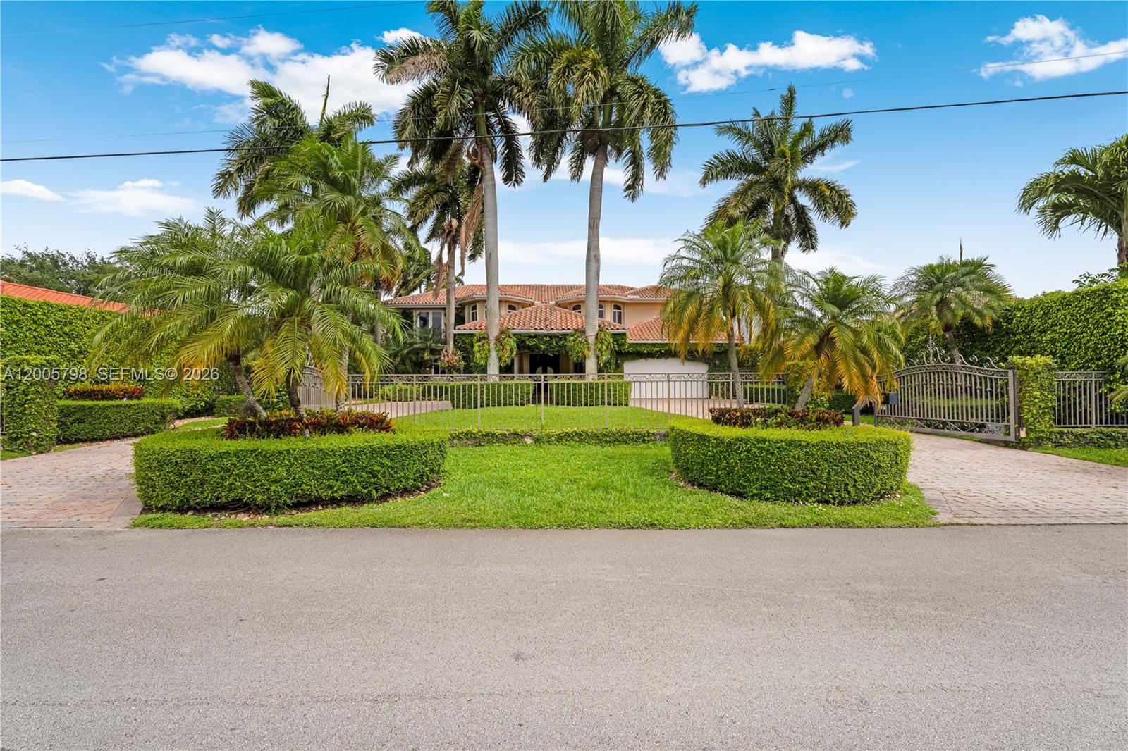 11071 Southwest 28th Street Miami, FL 33165 - Photo 65 of 78 a front view of a house with a yard and palm trees
