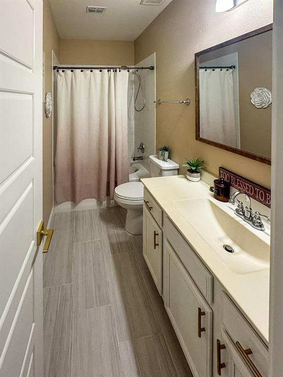 7024 Tree Stand Point Little Elm, TX 76227 - Photo 18 of 30 a spacious bathroom with a double vanity sink and mirror