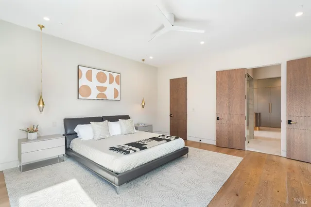 a large bathroom with a glass shower door and a mirror