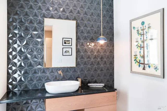 a bedroom with a bed and painting on the wall