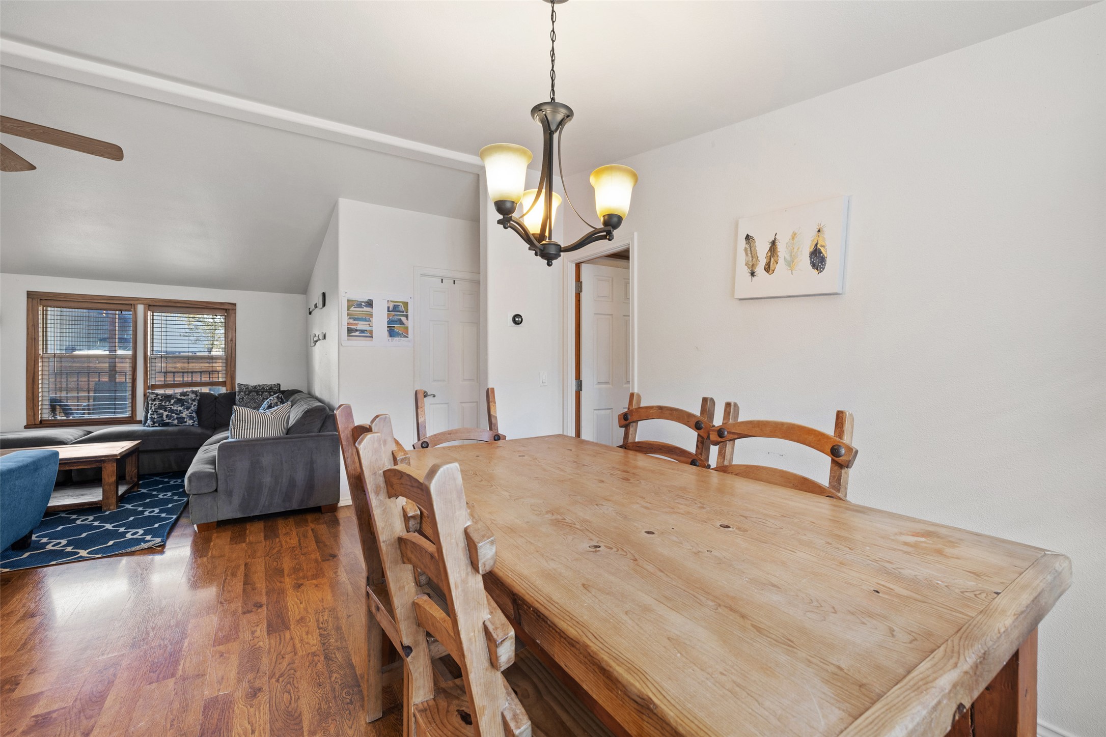 5519 Hiline Road Austin, TX 78734 - Photo 11 of 40 Dining room with dark wood-style flooring, vaulted ceiling, and ceiling fan with notable chandelier