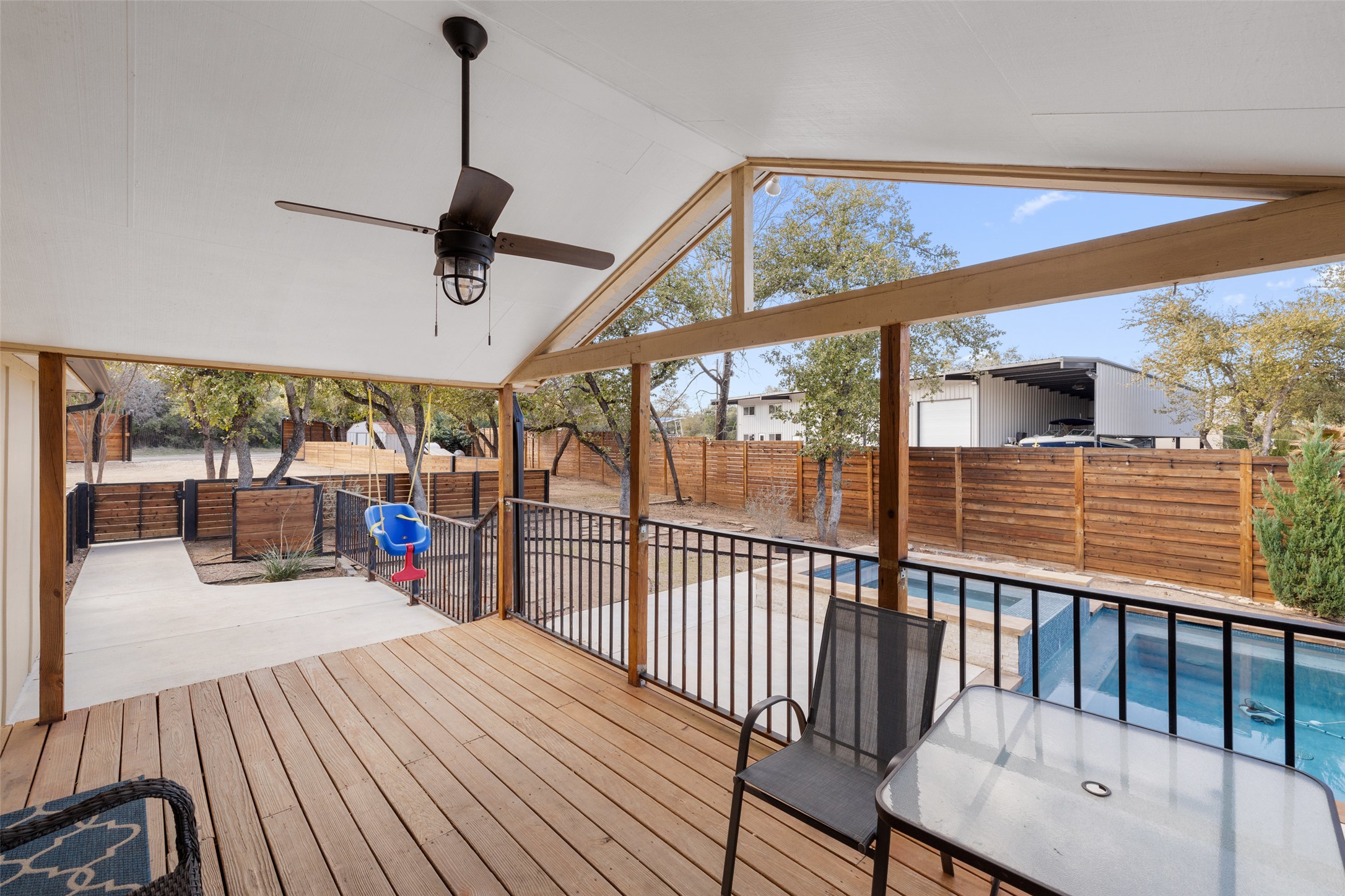 5519 Hiline Road Austin, TX 78734 - Photo 25 of 40 Wooden terrace featuring a fenced in pool, a patio area, a fenced backyard, and ceiling fan