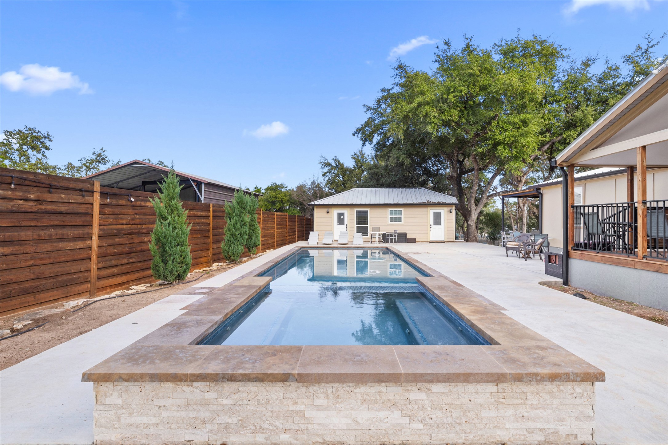 5519 Hiline Road Austin, TX 78734 - Photo 36 of 40 View of swimming pool with a patio area, a fenced backyard, a fenced in pool, and an outbuilding