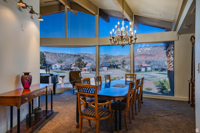 980 Cactus Circle St. George, UT 84790 - Photo 4 of 77 Dining room with a mountain view, carpet flooring, suspended lighting, beam ceiling, and a residential view