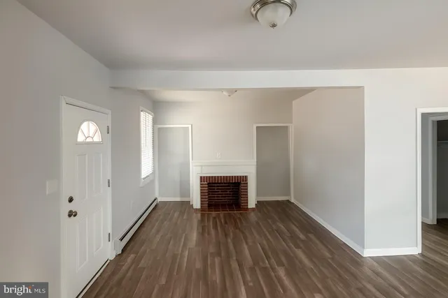 an empty room with windows and a ceiling fan view