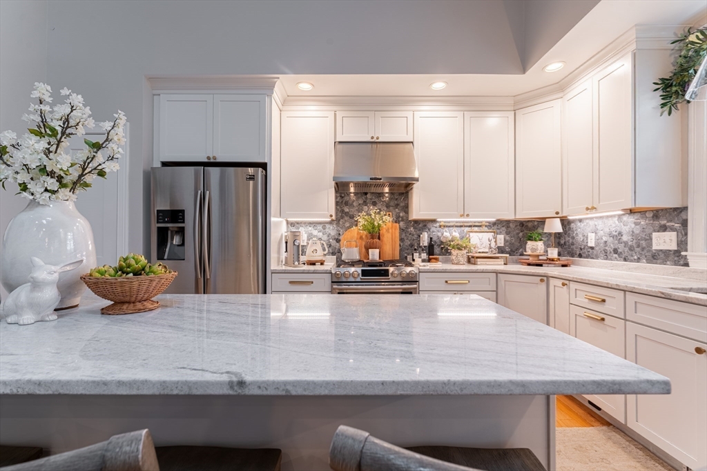 38 Cherry Street, Unit B Hudson, MA 01749 - Photo 5 of 33 a kitchen with sink a refrigerator and white cabinets