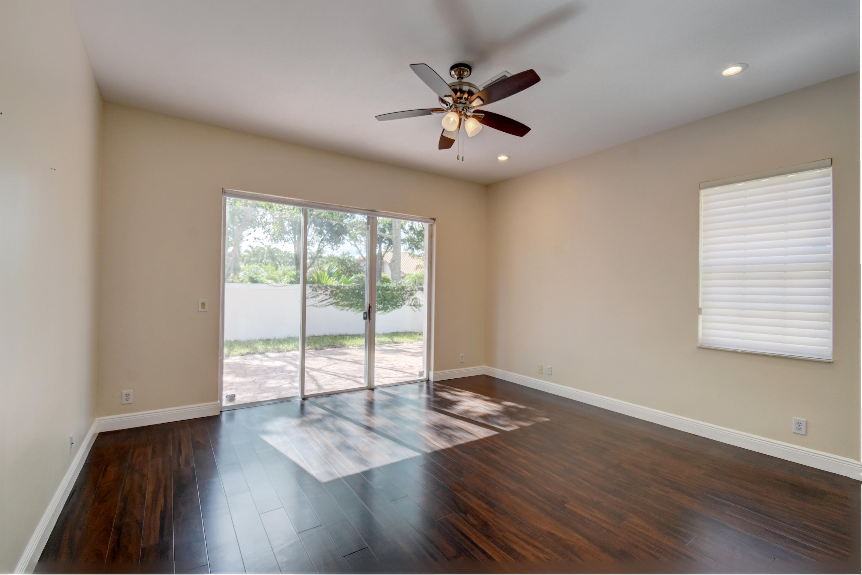 6286 Northwest 23rd Road Boca Raton, FL 33434 - Photo 19 of 44 a view of an empty room with wooden floor and a window