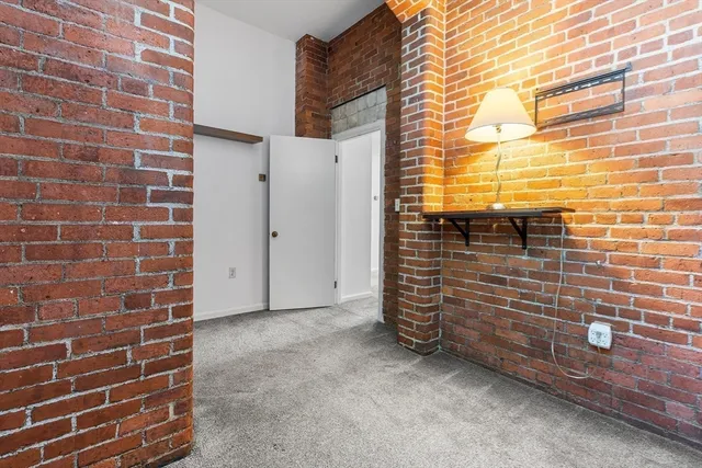 a view of outdoor space with brick wall