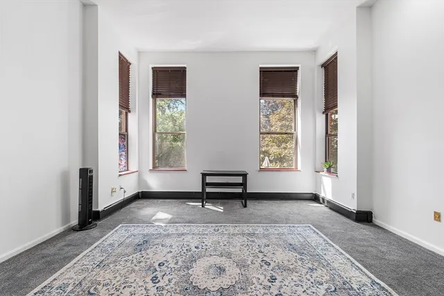 a living room with a couch and a window
