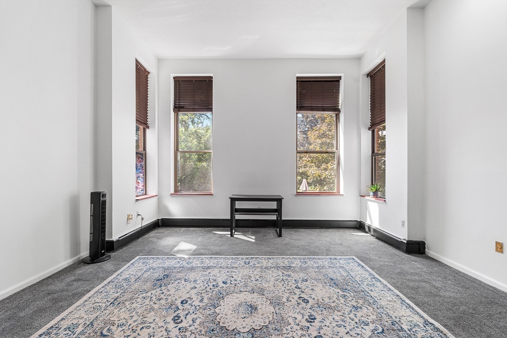 141 Savin Hill Avenue, Unit A22 Boston, MA 02125 - Photo 3 of 15 a living room with a couch and a window