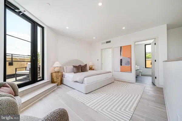 a spacious bedroom with a large bed and a couch