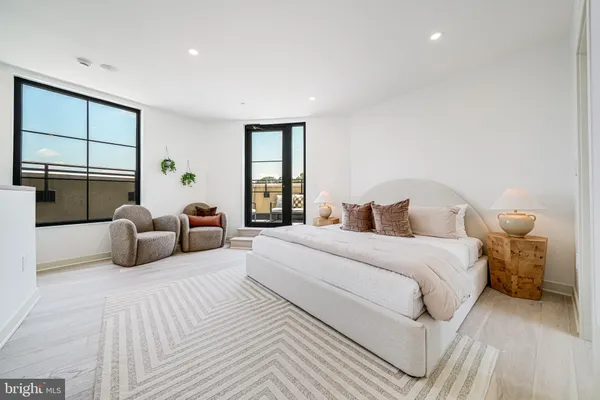 a bedroom with a large bed and a window