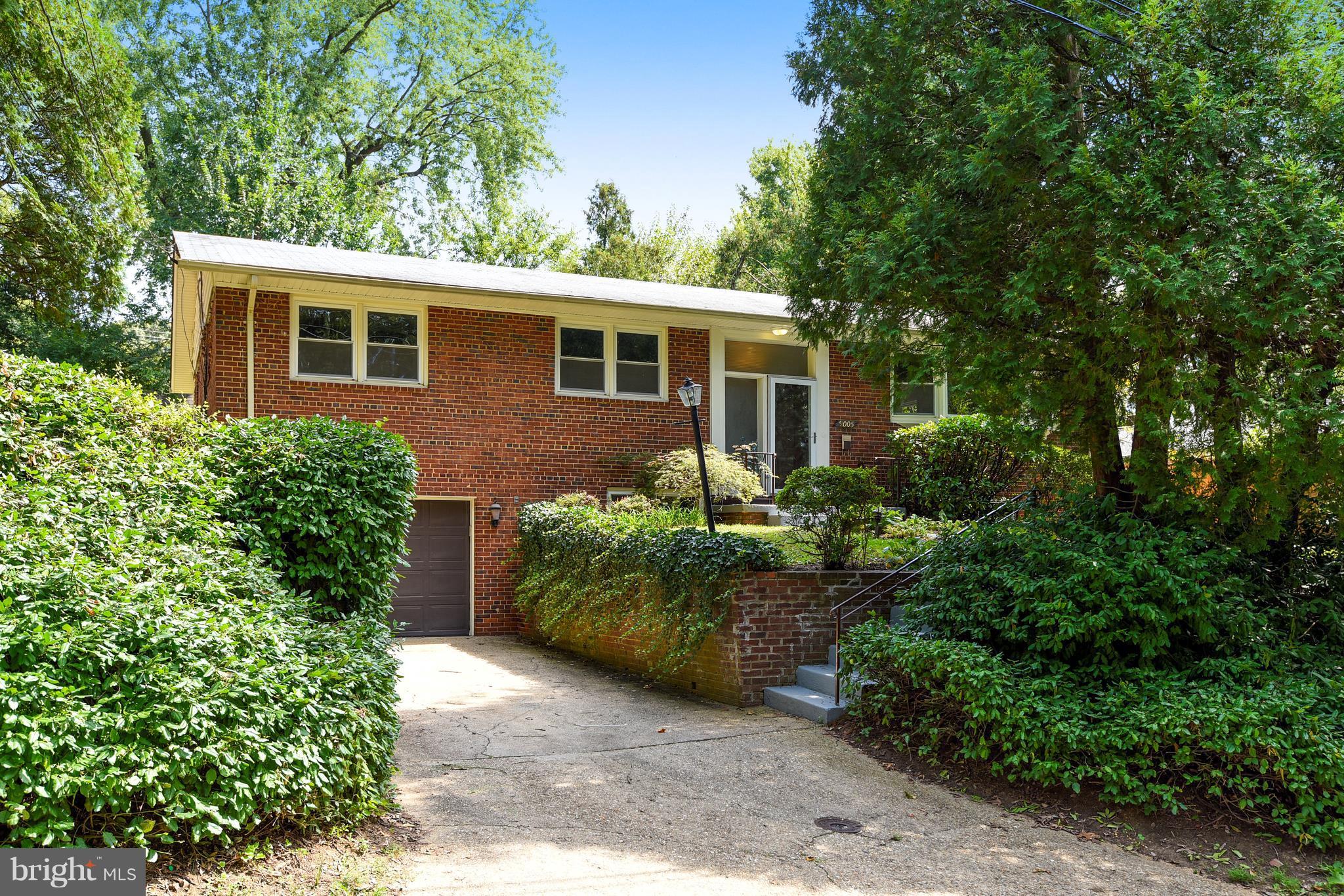 9005 Bradford Road Silver Spring, MD 20901 - Photo 1 of 28 a front view of a house with a garden