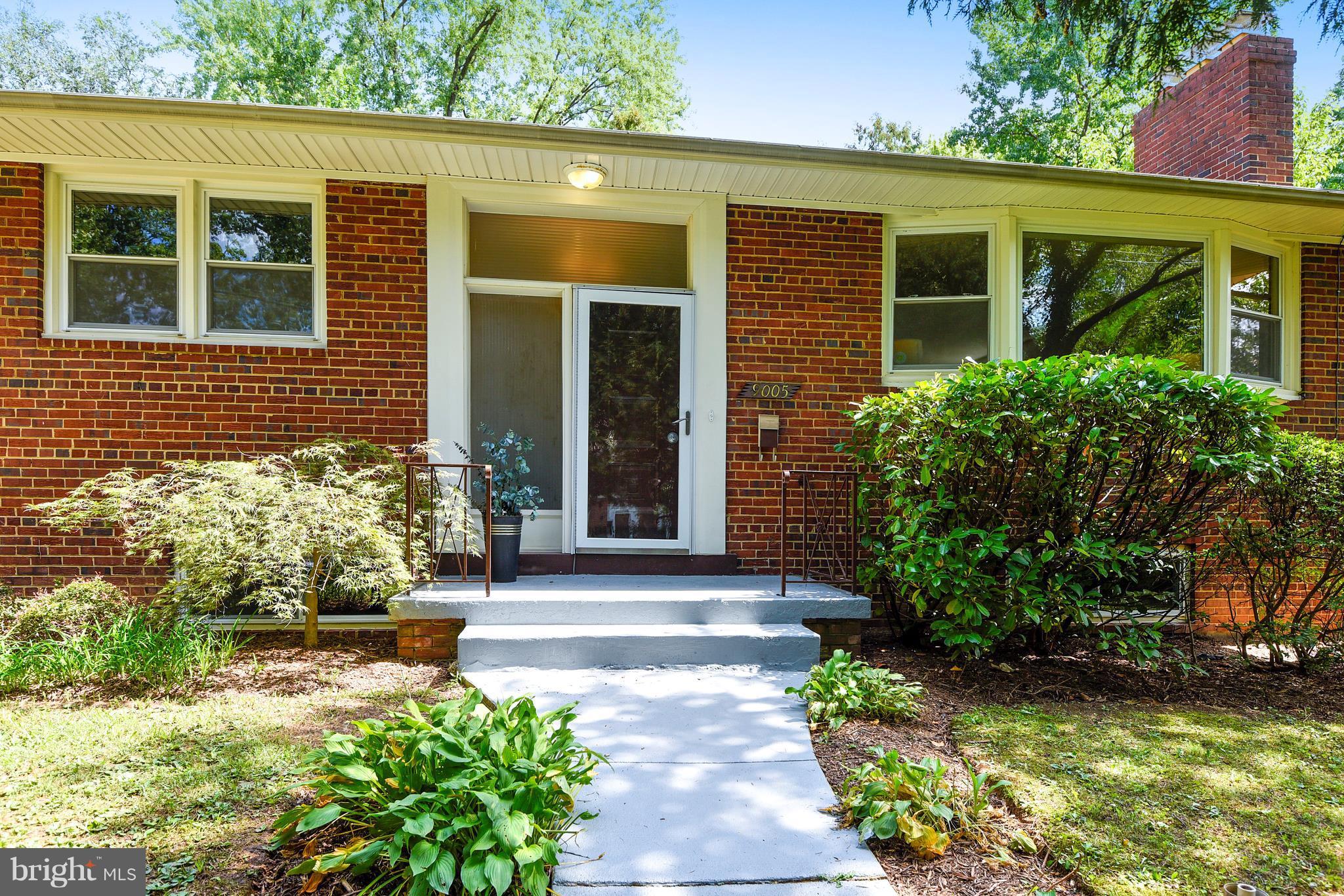 9005 Bradford Road Silver Spring, MD 20901 - Photo 2 of 28 a front view of a house with garden