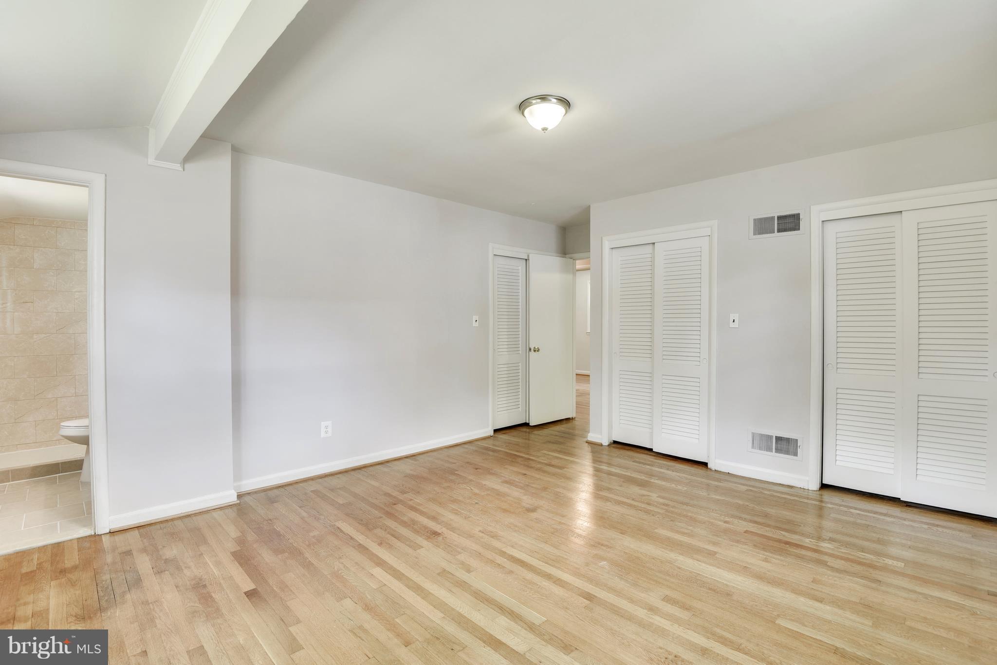 9005 Bradford Road Silver Spring, MD 20901 - Photo 12 of 28 a view of an empty room with wooden floor