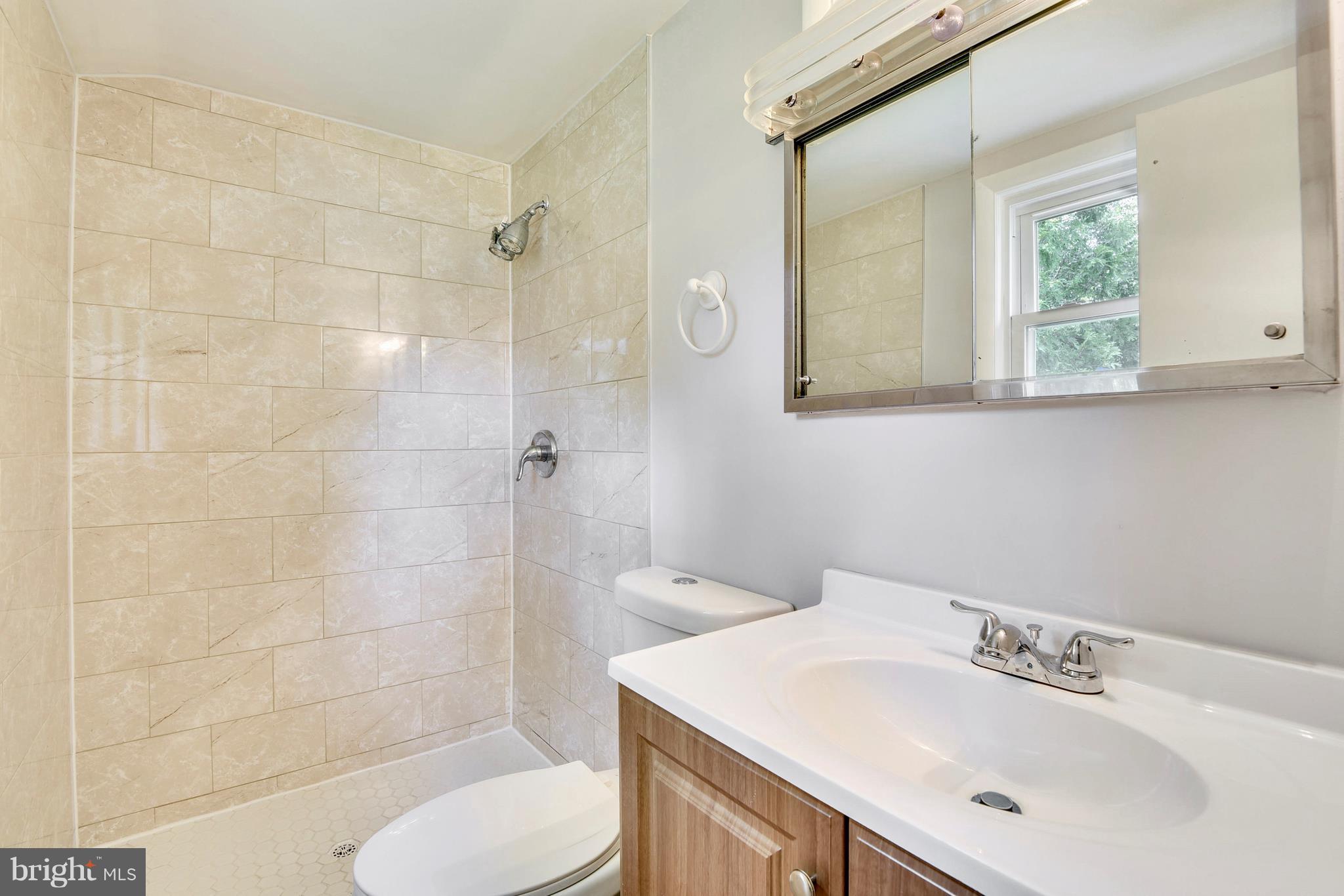 9005 Bradford Road Silver Spring, MD 20901 - Photo 14 of 28 a bathroom with a sink toilet and shower