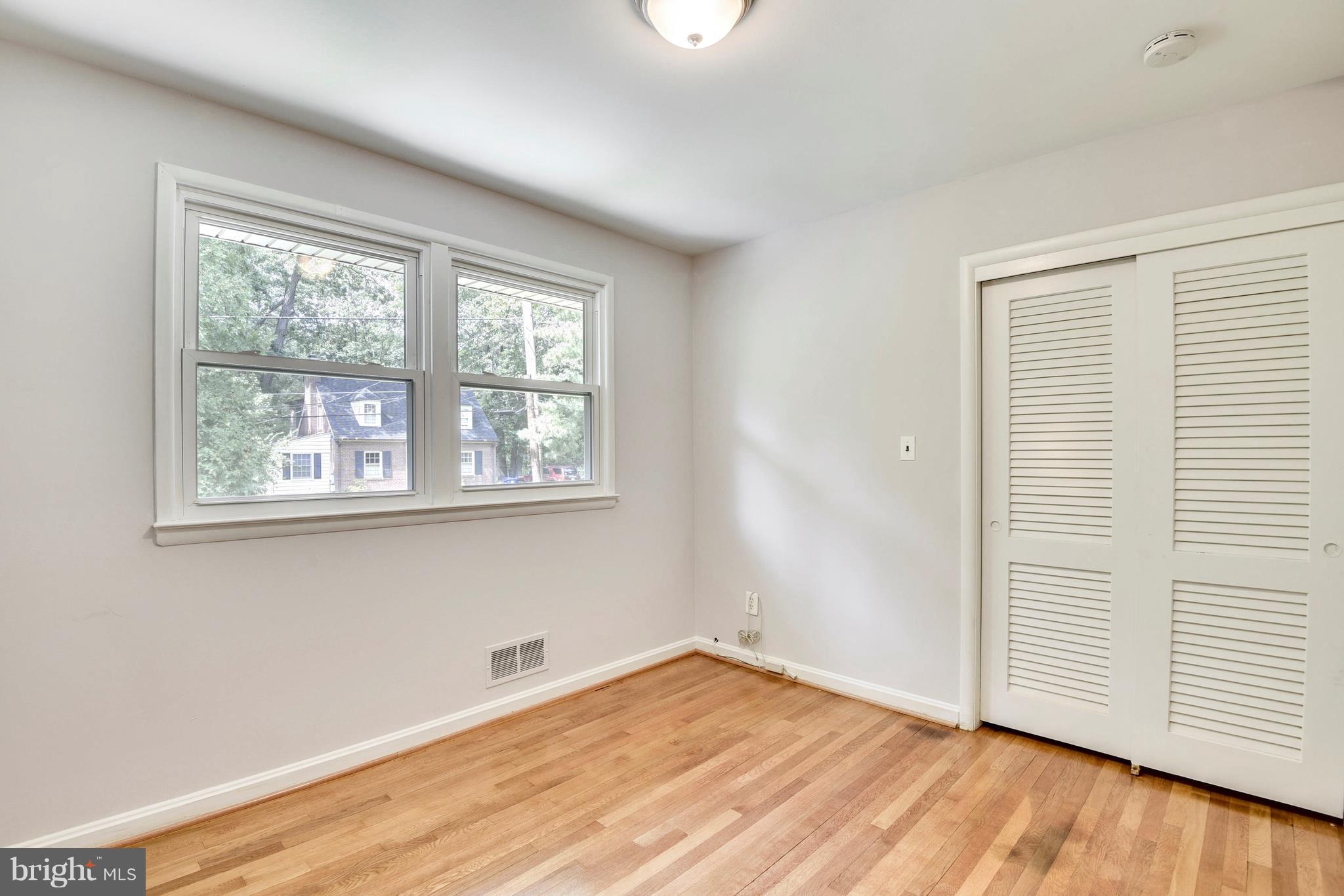 9005 Bradford Road Silver Spring, MD 20901 - Photo 15 of 28 an empty room with wooden floor and windows