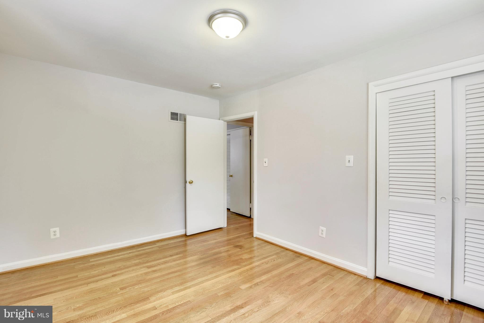 9005 Bradford Road Silver Spring, MD 20901 - Photo 16 of 28 wooden floor in an empty room with a window