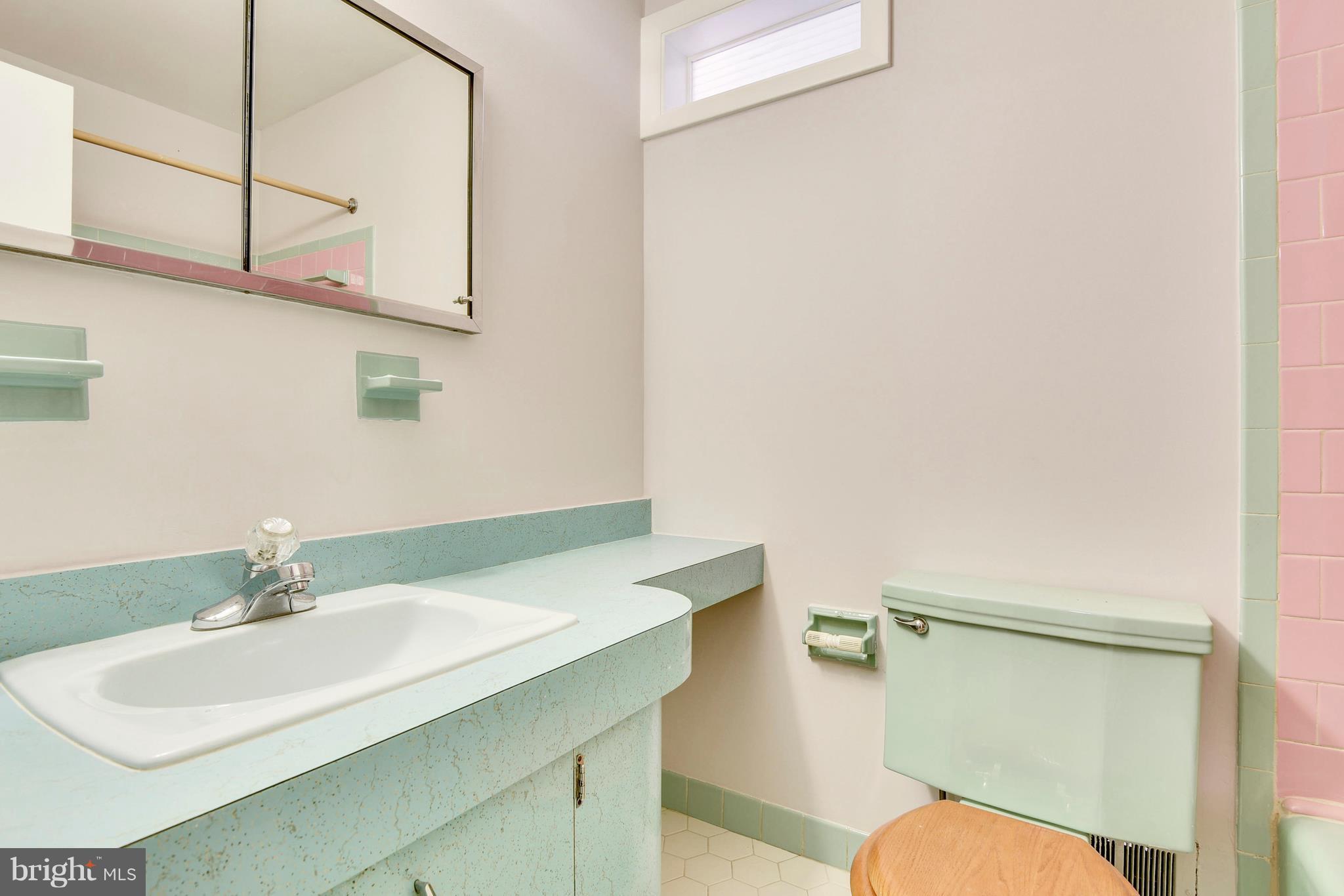 9005 Bradford Road Silver Spring, MD 20901 - Photo 17 of 28 a bathroom with a sink toilet and a mirror