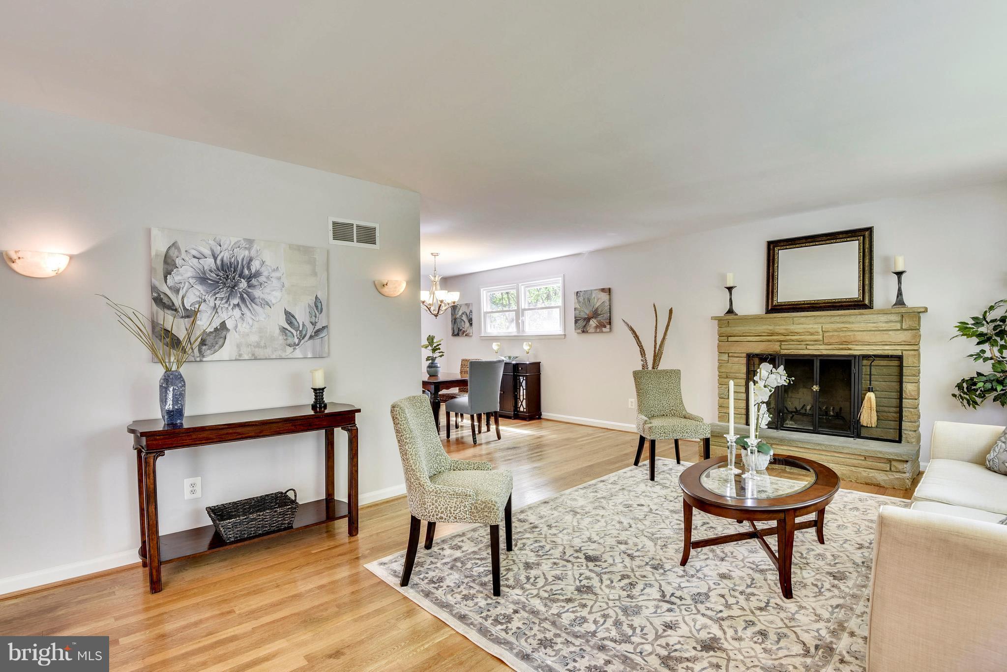 9005 Bradford Road Silver Spring, MD 20901 - Photo 5 of 28 a living room with furniture a table and a fireplace