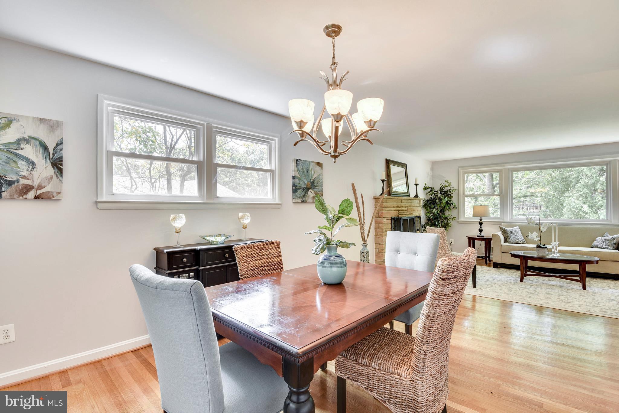 9005 Bradford Road Silver Spring, MD 20901 - Photo 6 of 28 a view of a dining room with furniture a chandelier and wooden floor