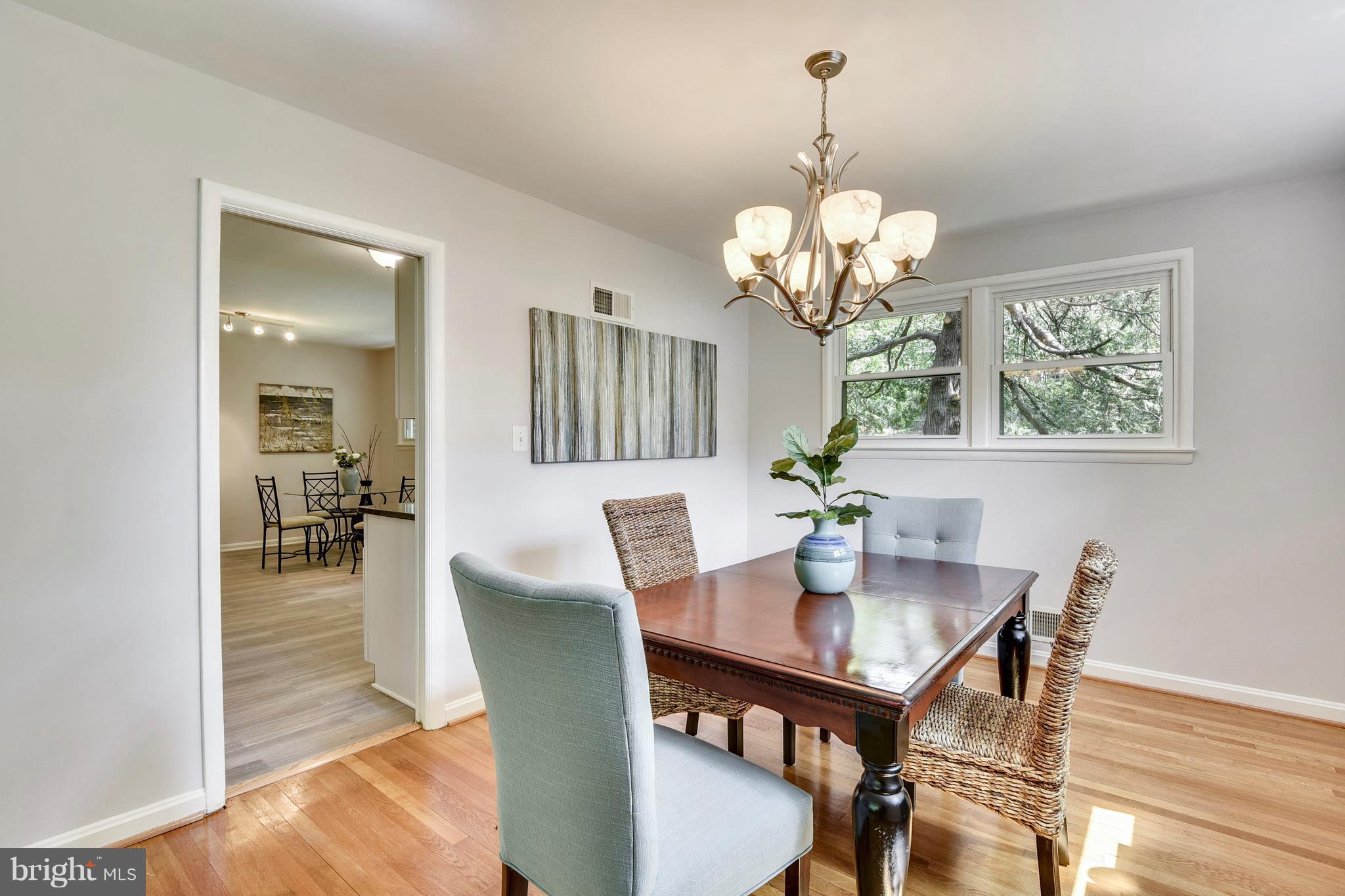 9005 Bradford Road Silver Spring, MD 20901 - Photo 7 of 28 a view of a dining room with furniture wooden floor and chandelier