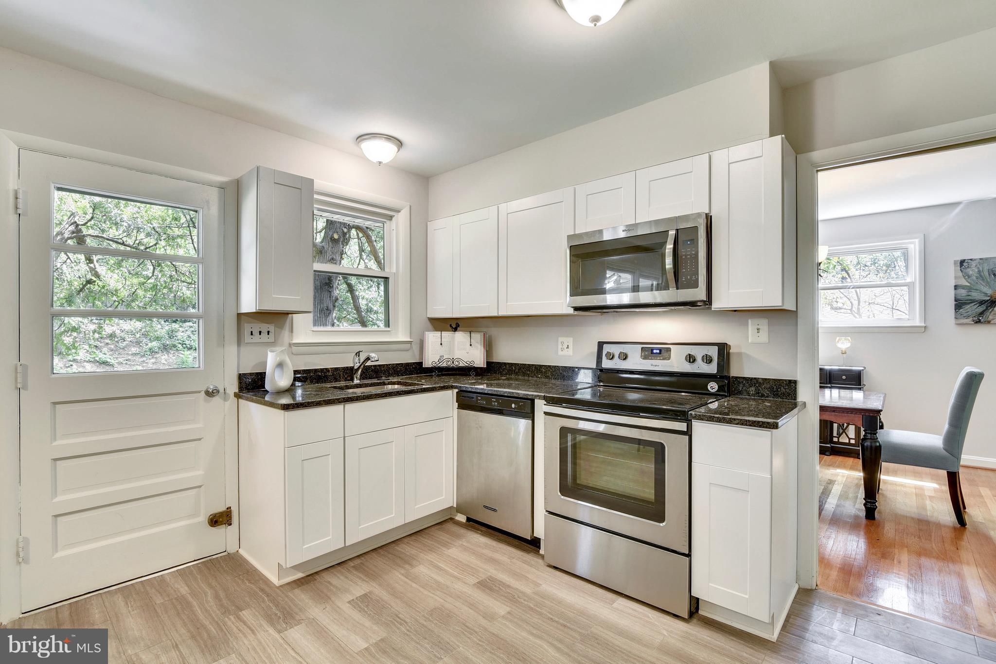9005 Bradford Road Silver Spring, MD 20901 - Photo 9 of 28 a kitchen with a stove a sink and a microwave