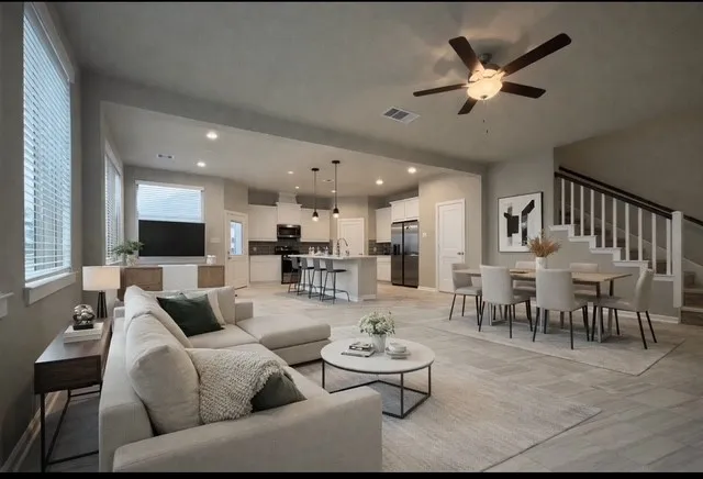 a living room with furniture kitchen view and a flat screen tv