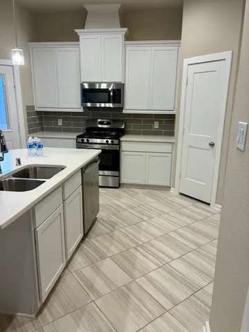 a kitchen with stainless steel appliances granite countertop a sink and cabinets