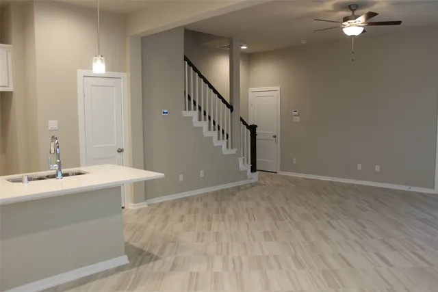 a view of a room with a sink and mirror