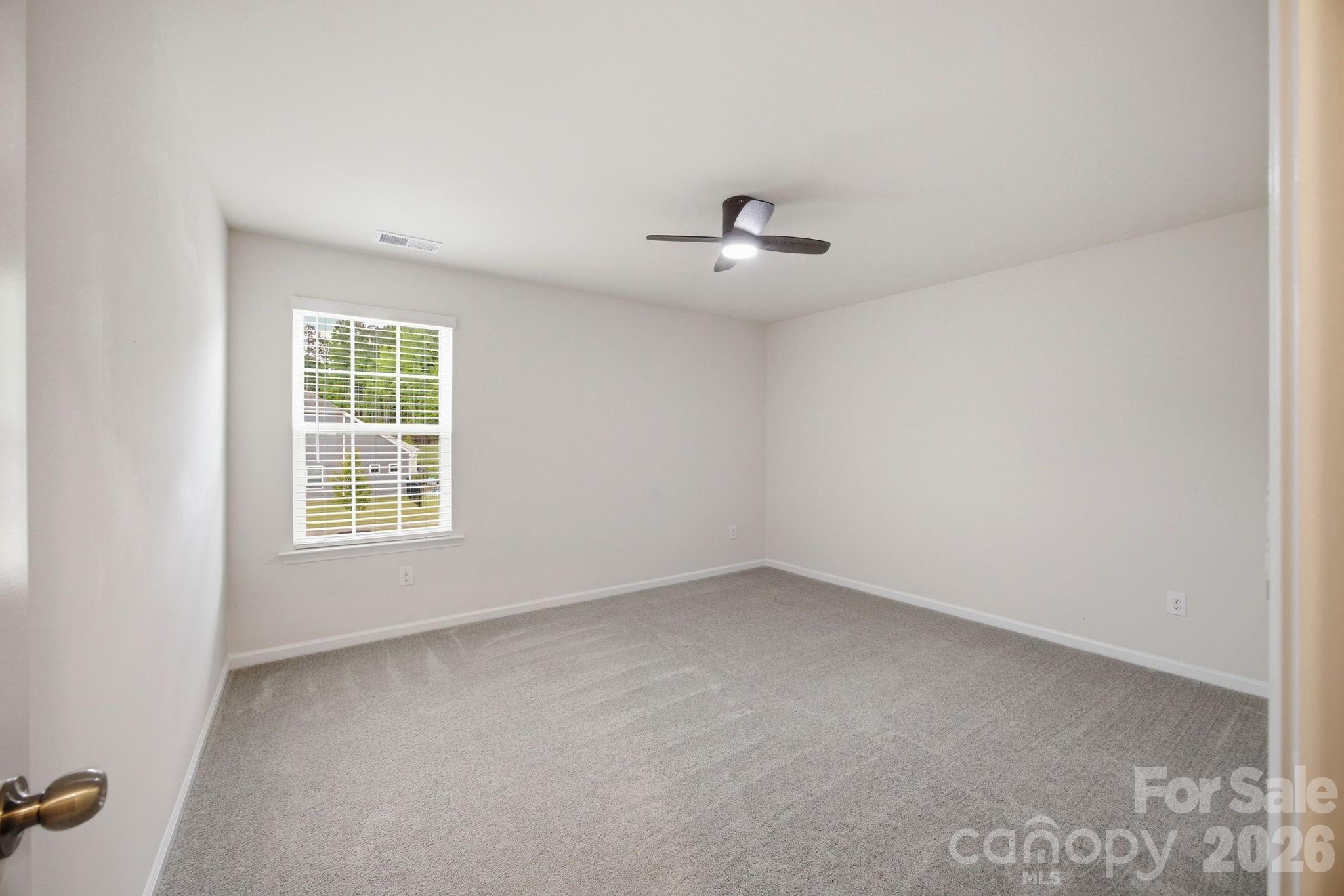 234 Hamptons Cove Road Troutman, NC 28166 - Photo 20 of 32 an empty room with a empty space and windows