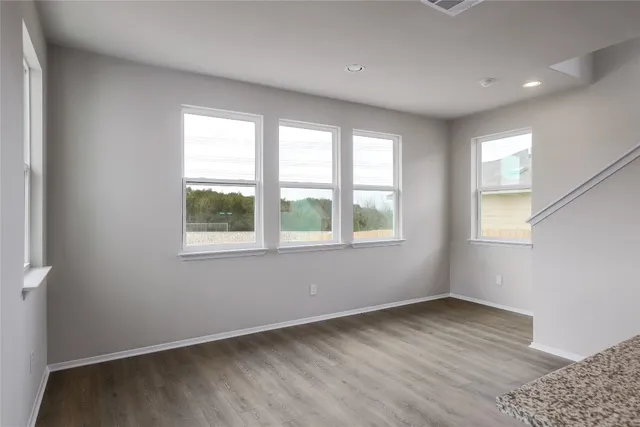 a kitchen with granite countertop stainless steel appliances a stove a sink a microwave and cabinets