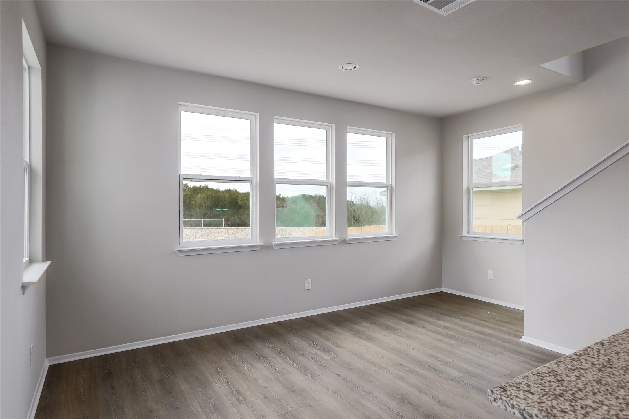 11416 Milano Drive Austin, TX 78747 - Photo 10 of 25 Empty room with light wood-type flooring and recessed lighting