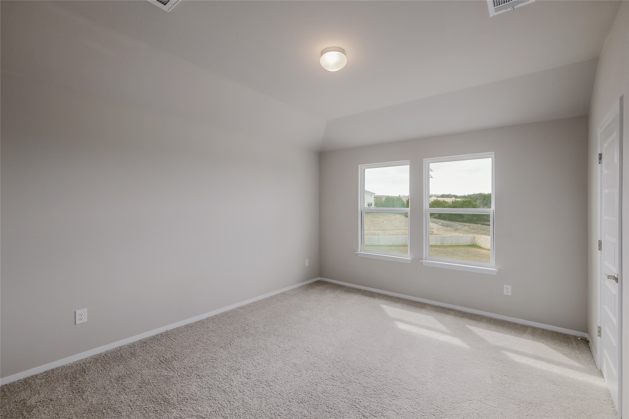 11416 Milano Drive Austin, TX 78747 - Photo 12 of 25 Unfurnished room with carpet floors and vaulted ceiling