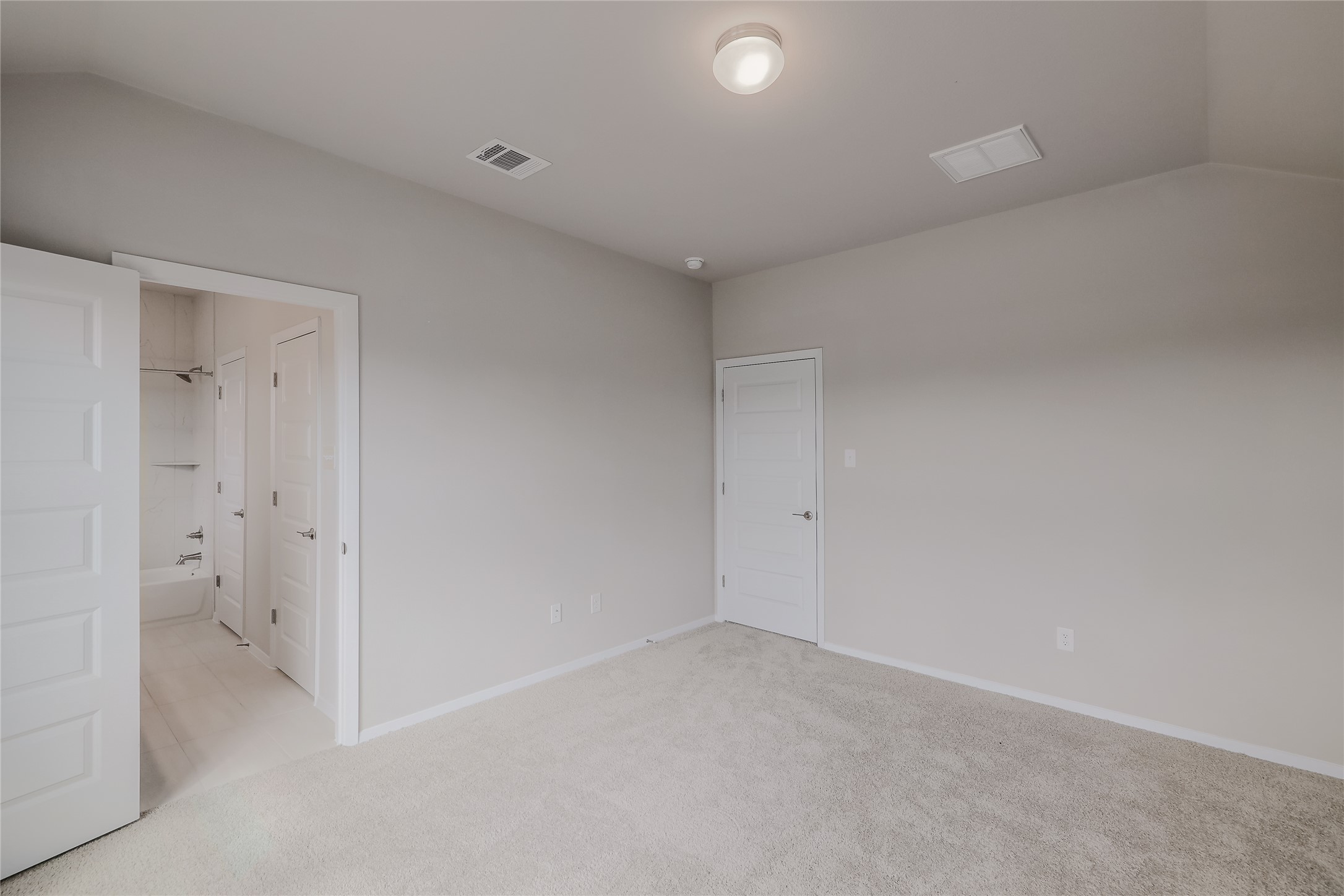 11416 Milano Drive Austin, TX 78747 - Photo 13 of 25 Unfurnished bedroom with light carpet and lofted ceiling