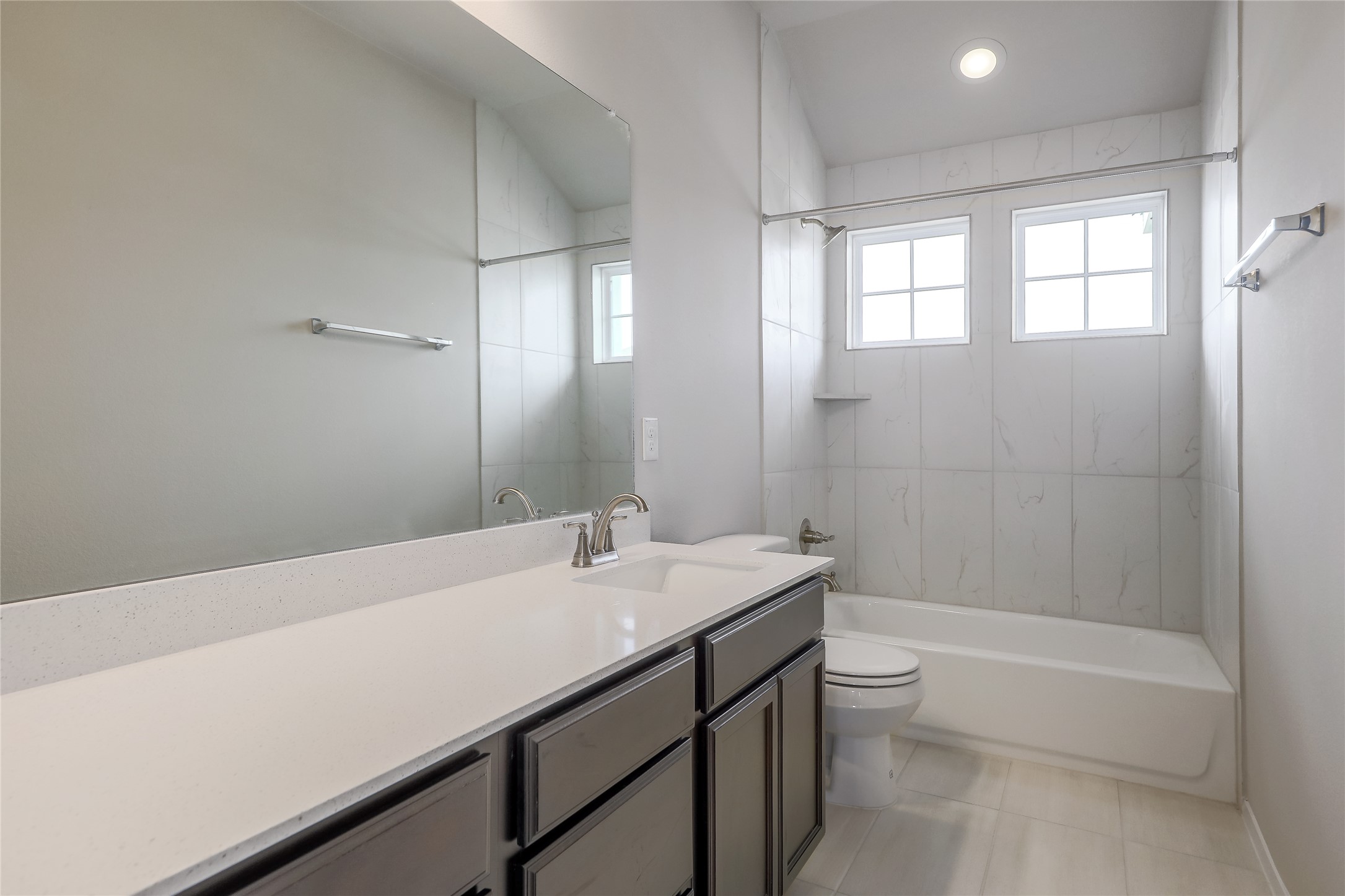 11416 Milano Drive Austin, TX 78747 - Photo 18 of 25 Full bathroom featuring vanity, shower / tub combination, and light tile patterned floors