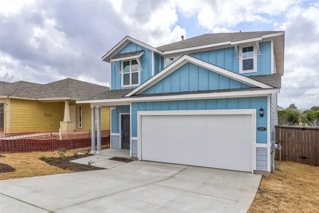 a front view of a house with a yard and garage