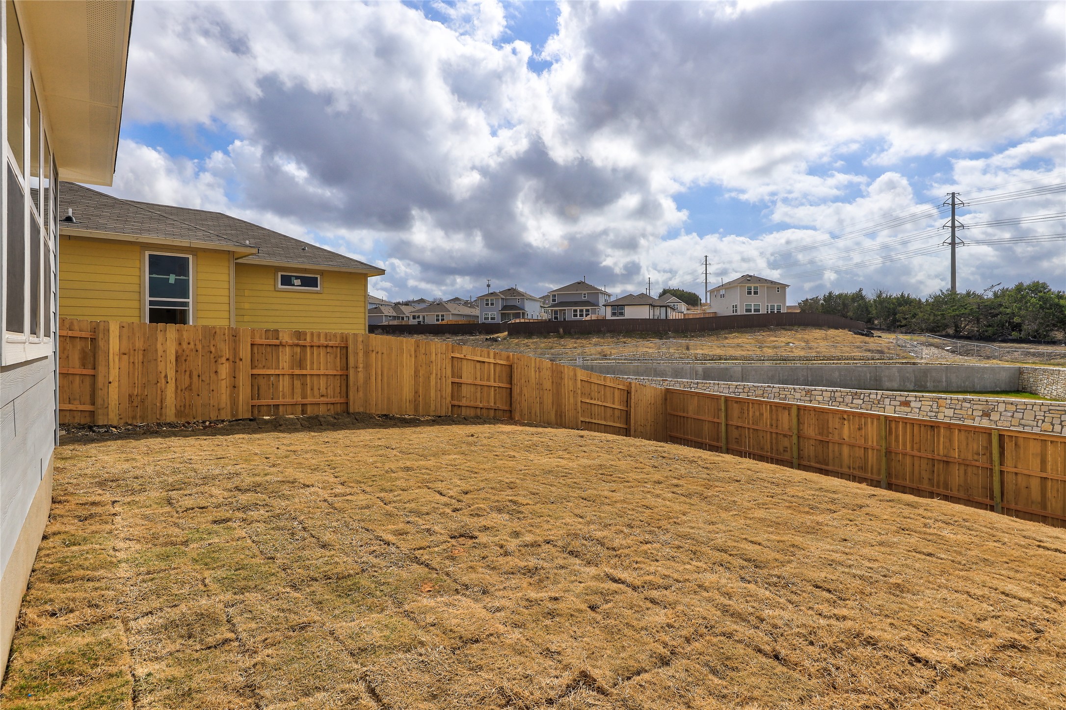 11416 Milano Drive Austin, TX 78747 - Photo 21 of 25 Fenced backyard with a residential view