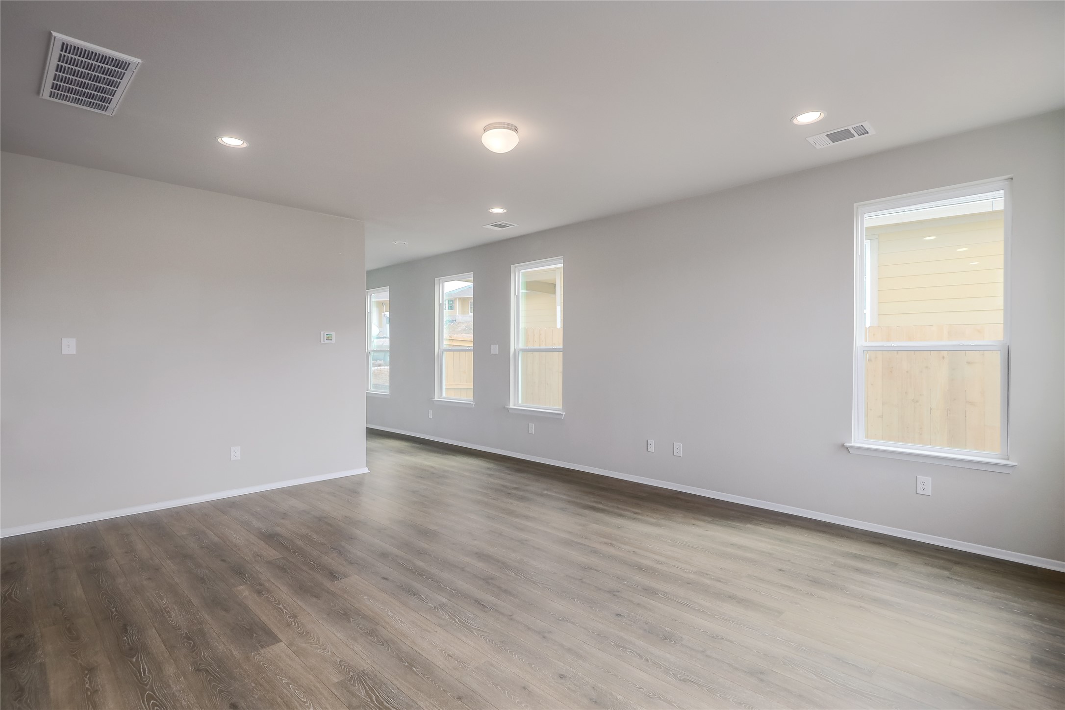 11416 Milano Drive Austin, TX 78747 - Photo 6 of 25 Unfurnished room with light wood-type flooring and recessed lighting
