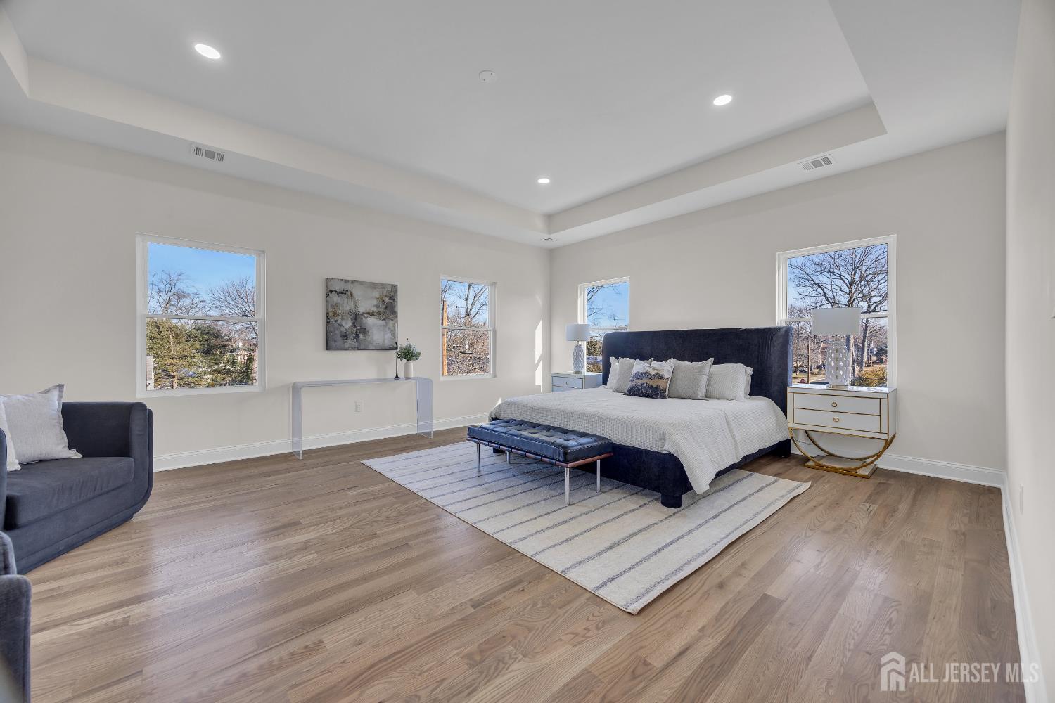 265 West Prescott Avenue Edison, NJ 08820 - Photo 42 of 56 a spacious bedroom with a bed a couch and paintings on the wall