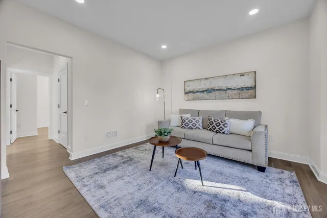 a dining room with furniture a chandelier and wooden floor