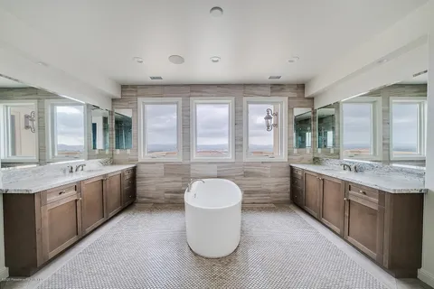 a bathroom with a bathtub sink and mirror