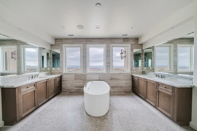 a bathroom with a bathtub sink and mirror