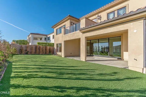 a view of a house with a yard and sitting area