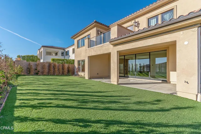 a view of a house with a yard and sitting area