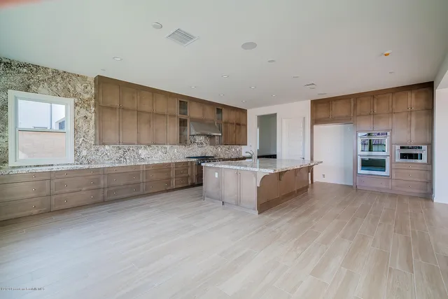 a kitchen with stainless steel appliances granite countertop a sink stove and cabinets