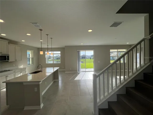 a kitchen with stainless steel appliances a stove sink microwave and cabinets