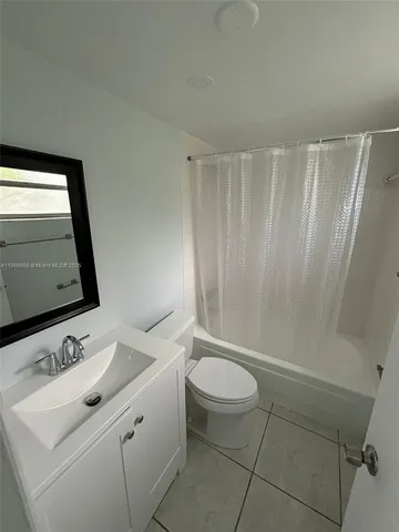 a bathroom with a sink a toilet and tub
