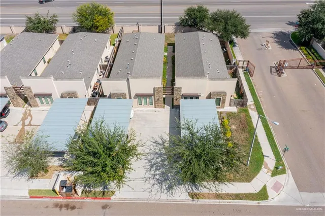 an aerial view of residential houses with outdoor space